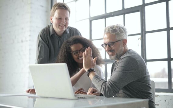 Happy multiracial colleagues giving high five to each other 3866338